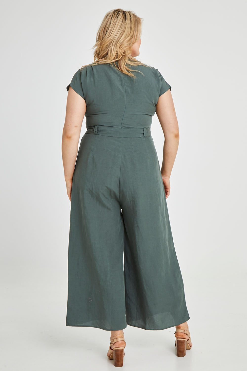 Model Keeara wearing size 16 of the Linen Blend Jumpsuit in colour Green (Green), from the back