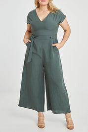 Model Keeara wearing size 16 of the Linen Blend Jumpsuit in colour Green (Green), from the front, cropped image