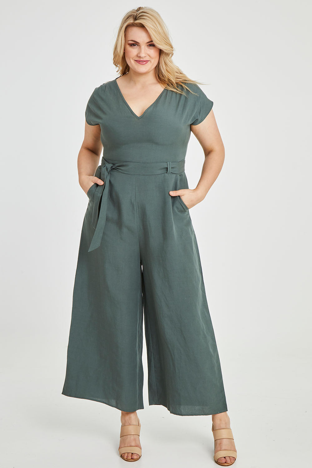 Model Keeara wearing size 16 of the Linen Blend Jumpsuit in colour Green (Green), from the front, showing the whole outfit