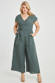 Model Keeara wearing size 16 of the Linen Blend Jumpsuit in colour Green (Green), from the front, showing the whole outfit