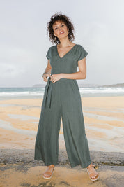 Model Lala wearing size 10 of the Linen Blend Jumpsuit in colour Green (Green), from the front, showing the whole outfit