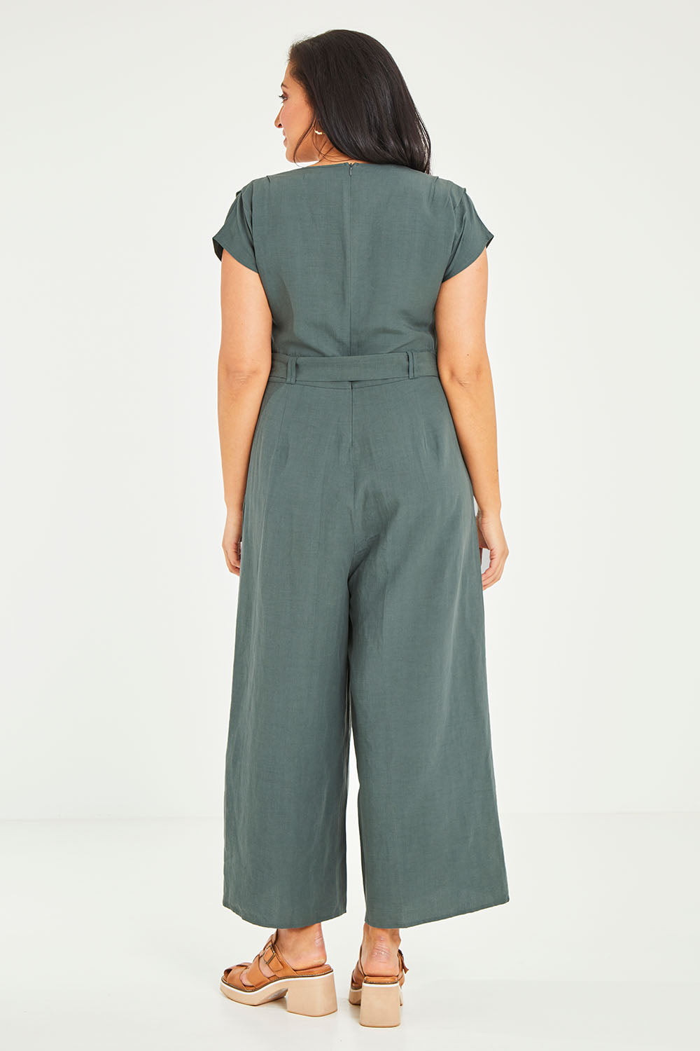 Model Terri-Leigh wearing size 14 of the Linen Blend Jumpsuit in colour Green (Green), from the back