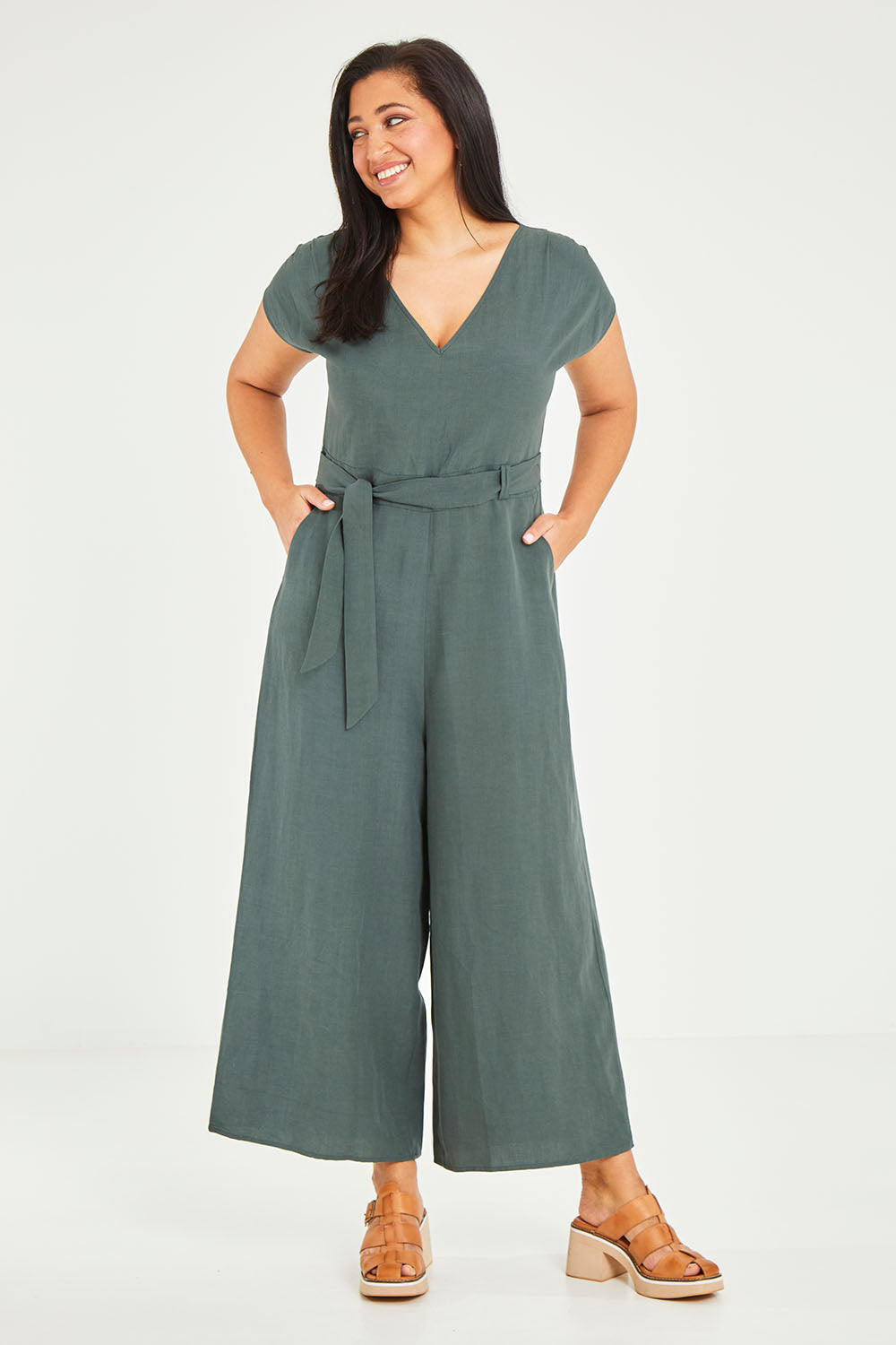 Model Terri-Leigh wearing size 14 of the Linen Blend Jumpsuit in colour Green (Green), from the front, showing the whole outfit