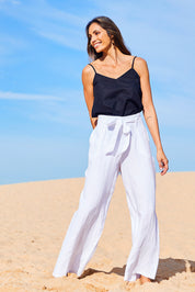 Model Amanda wearing size 10 of the Linen Long Line Pants in colour Salt (White), from the front, showing the whole outfit
