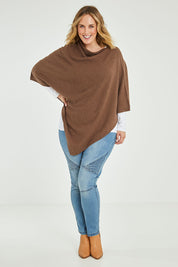 Model Jess wearing size L of the Cotton Cashmere Wool Poncho in colour Richearth, from the front, showing the whole outfit
