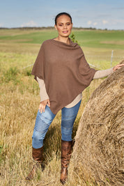 Model Lala wearing size S of the Cotton Cashmere Wool Poncho in colour Richearth, from the front, showing the whole outfit