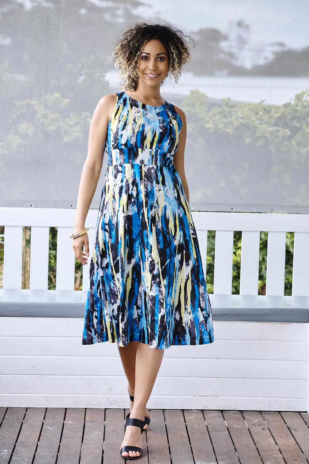 A model wearing the Troy Dress in colour Print (Blue), from the front, showing the whole outfit