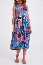 Model Emma wearing size 10 of the Printed Organic Cotton Dress in colour Orientblue (Blue), from the front, cropped image