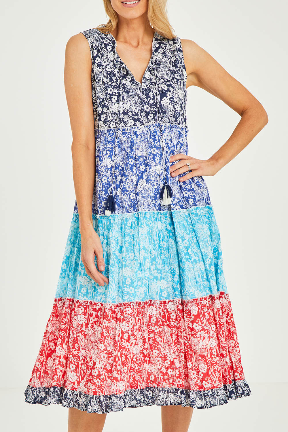 Model Kelly wearing size 10 of the Cappadocia Organic Cotton Sleeveless Dress in colour Mix (Blue), from the front, cropped image