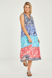Model Kelly wearing size 10 of the Cappadocia Organic Cotton Sleeveless Dress in colour Mix (Blue), from the front, showing the whole outfit