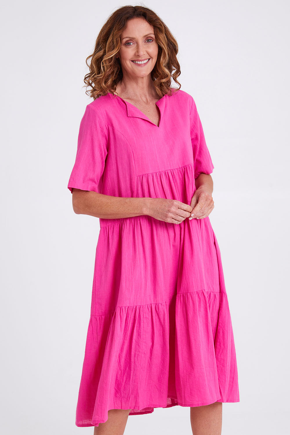 Model Emma wearing size 10 of the Collared Midi Organic Cotton Dress in colour Rose (Pink), from the front, cropped image