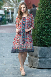 A model wearing the Urbino Print Dress in colour UrbinoPrin (Red), from the front, showing the whole outfit