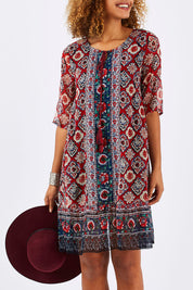Model Summer wearing size 10 of the Urbino Print Dress in colour UrbinoPrin (Red), from the front, cropped image