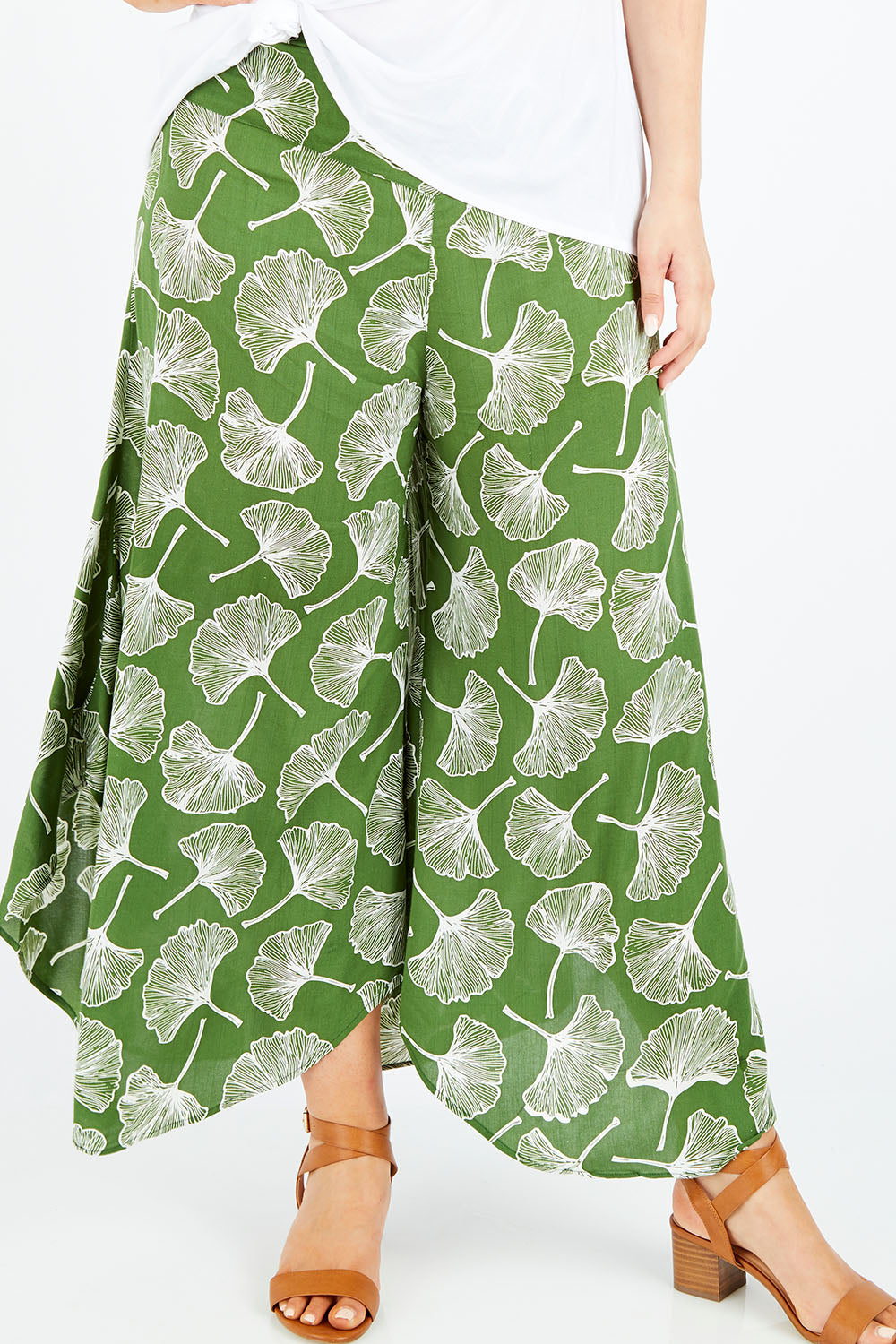 Model Jess wearing size L of the Rayon Flare Pant in colour Greenleaf (Green), from the front, cropped image