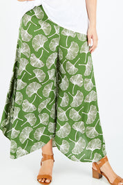Model Jess wearing size L of the Rayon Flare Pant in colour Greenleaf (Green), from the front, cropped image