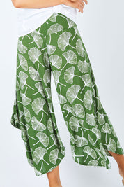 Model Madeline wearing size S of the Rayon Flare Pant in colour Greenleaf (Green), from the front, cropped image