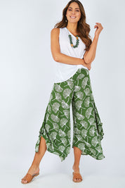 Model Madeline wearing size S of the Rayon Flare Pant in colour Greenleaf (Green), from the front, showing the whole outfit