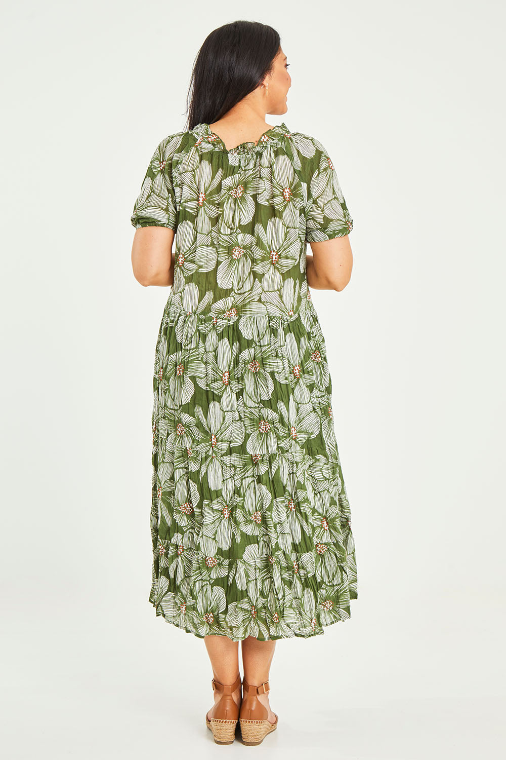 Model Terri-Leigh wearing size L of the Cotton Tiered Dress in colour Greenprint (Green), from the back