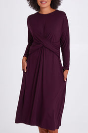 Model Olivia wearing size S of the Eden Bamboo Dress in colour Berry (Purple), from the front, cropped image