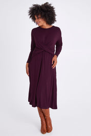 Model Olivia wearing size S of the Eden Bamboo Dress in colour Berry (Purple), from the front, showing the whole outfit