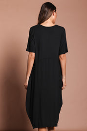 Model Madeline wearing the Soho S/S Dress in colour Black (Black), from the back