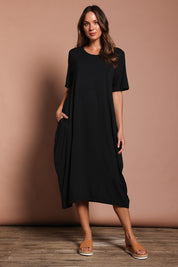 Model Madeline wearing the Soho S/S Dress in colour Black (Black), from the front, showing the whole outfit