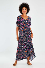Model Olivia wearing the Botanical Night Peak Maxi Dress in colour Botanical (Blue), from the front, showing the whole outfit
