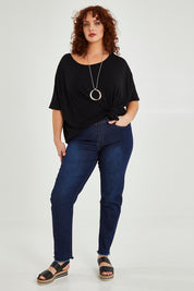 Model Maddy wearing size XXL of the Frayed Slim Fit Jean in colour Darkblue (Blue), from the front, showing the whole outfit