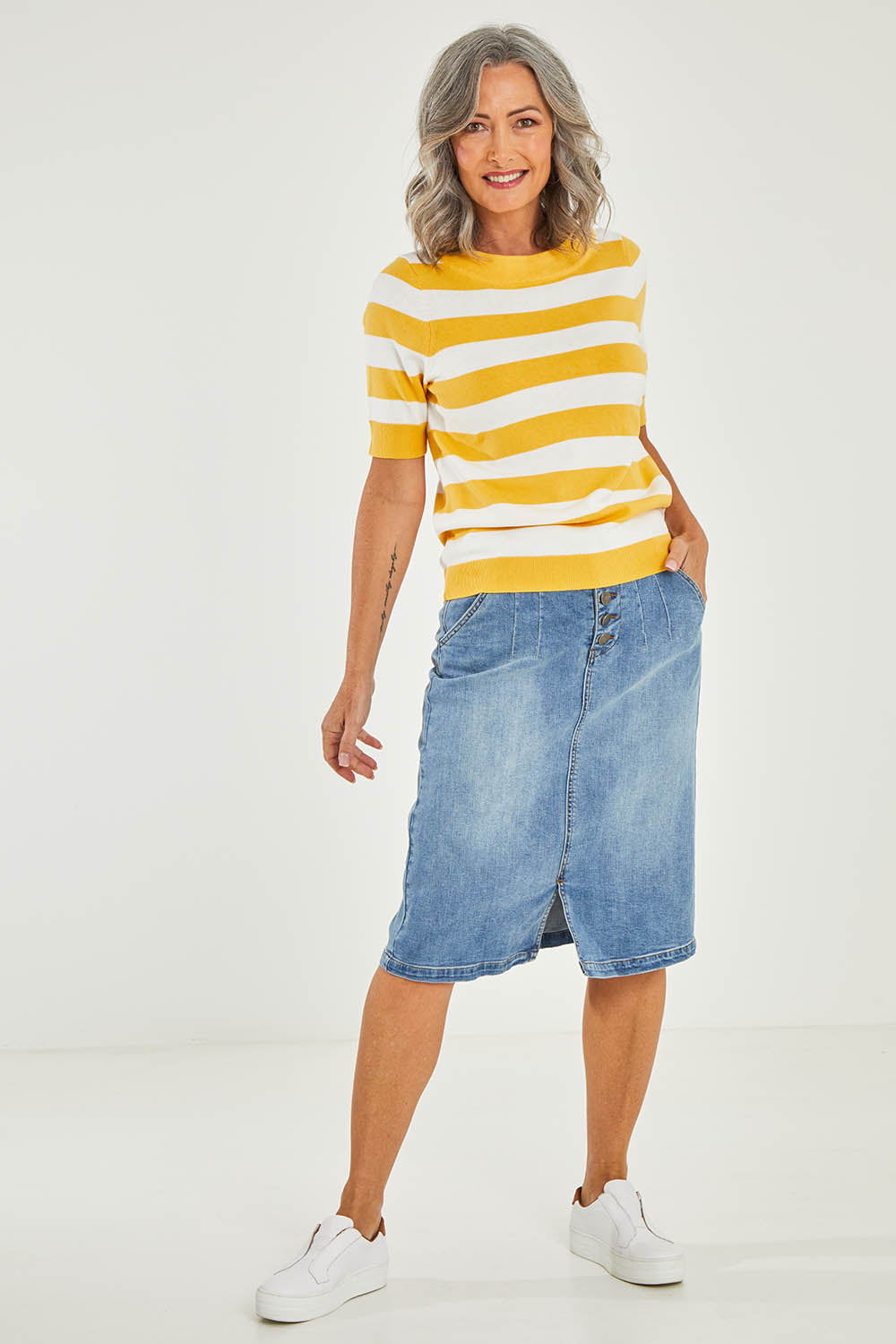 Model Luisa wearing size 10 of the Meadow Sweet Jumper in colour Yellow, from the front, showing the whole outfit