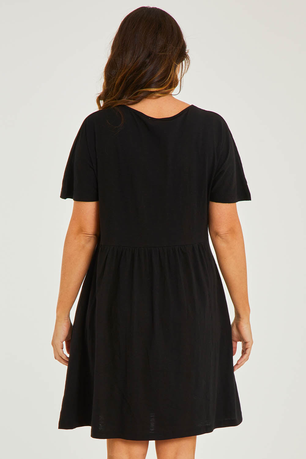 Model Georgia wearing size 10 of the Luna Ruched Dress in colour Black (Black), from the back