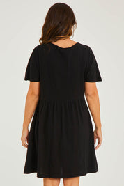 Model Georgia wearing size 10 of the Luna Ruched Dress in colour Black (Black), from the back