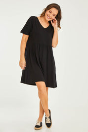 Model Georgia wearing size 10 of the Luna Ruched Dress in colour Black (Black), from the front, showing the whole outfit