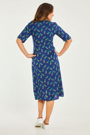 Model Georgia wearing size 10 of the Frenchie Dress in colour Pinapples (Blue), from the back