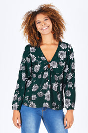 Model Summer wearing size 10 of the Magnolia Fields Keyhole Blouse in colour Magnolia (Green), from the front, cropped image