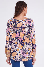 Model Madeline wearing size 10 of the Montana Boho Blouse in colour Navyfloral (Blue), from the back