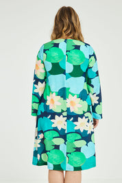 Model Jess wearing size 14 of the Foralskad Dress in colour Lilyblue (Blue), from the back