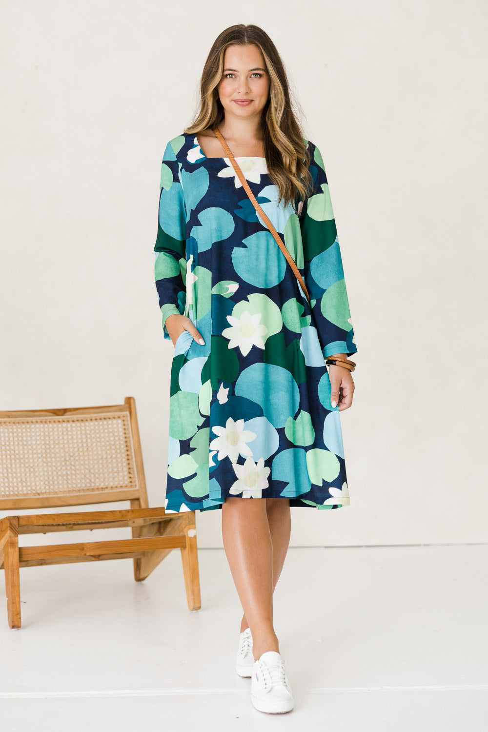 Model Tahlia wearing size 10 of the Foralskad Dress in colour Lilyblue (Blue), from the front, showing the whole outfit