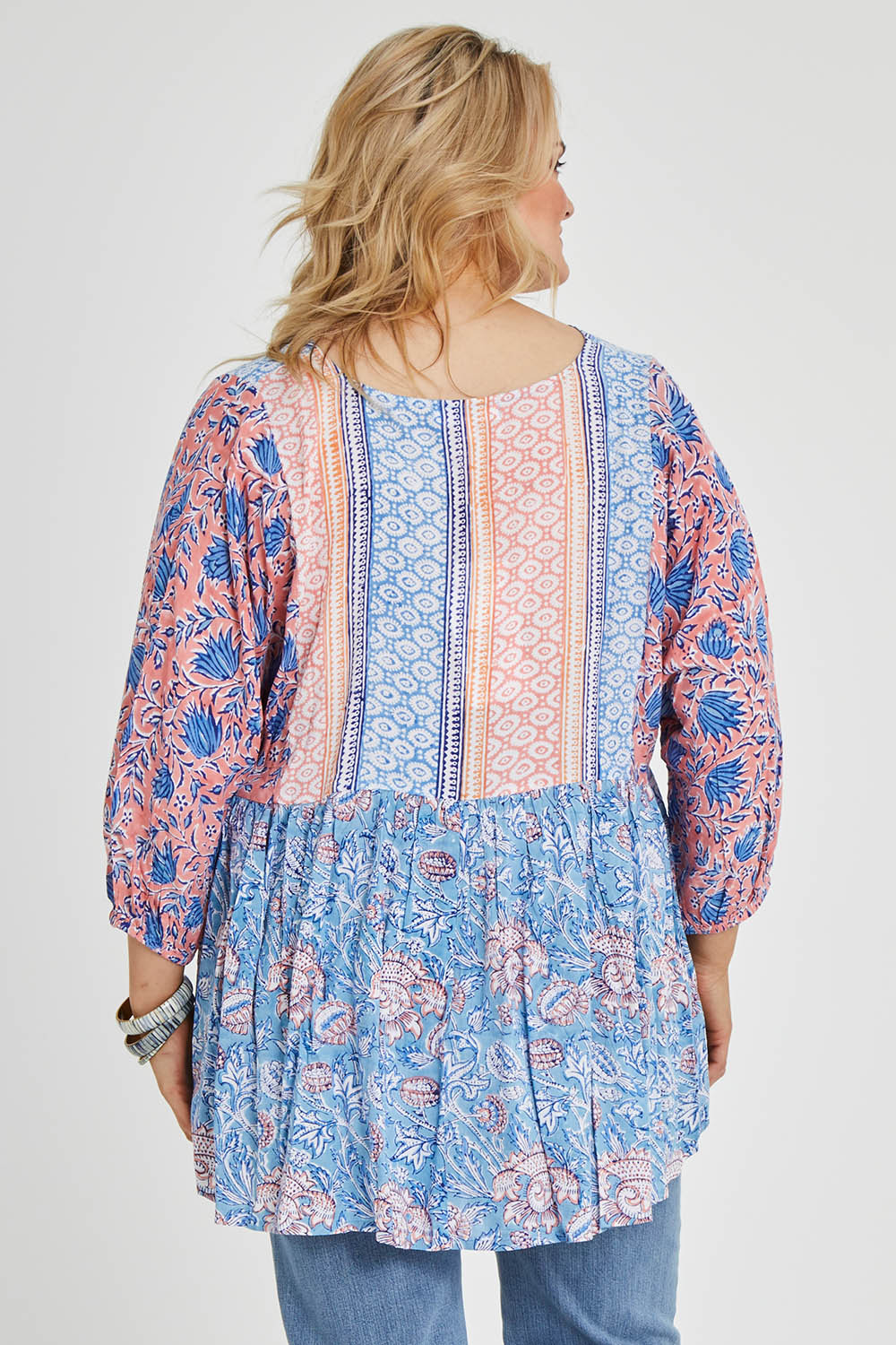 Model Keeara wearing size 16 of the Rosebud Beach Blouse in colour Coralblue (Blue), from the back