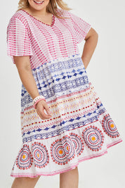 Model Keeara wearing size 16 of the Sealers Cove Cotton Dress in colour Multi (Red), from the front, cropped image