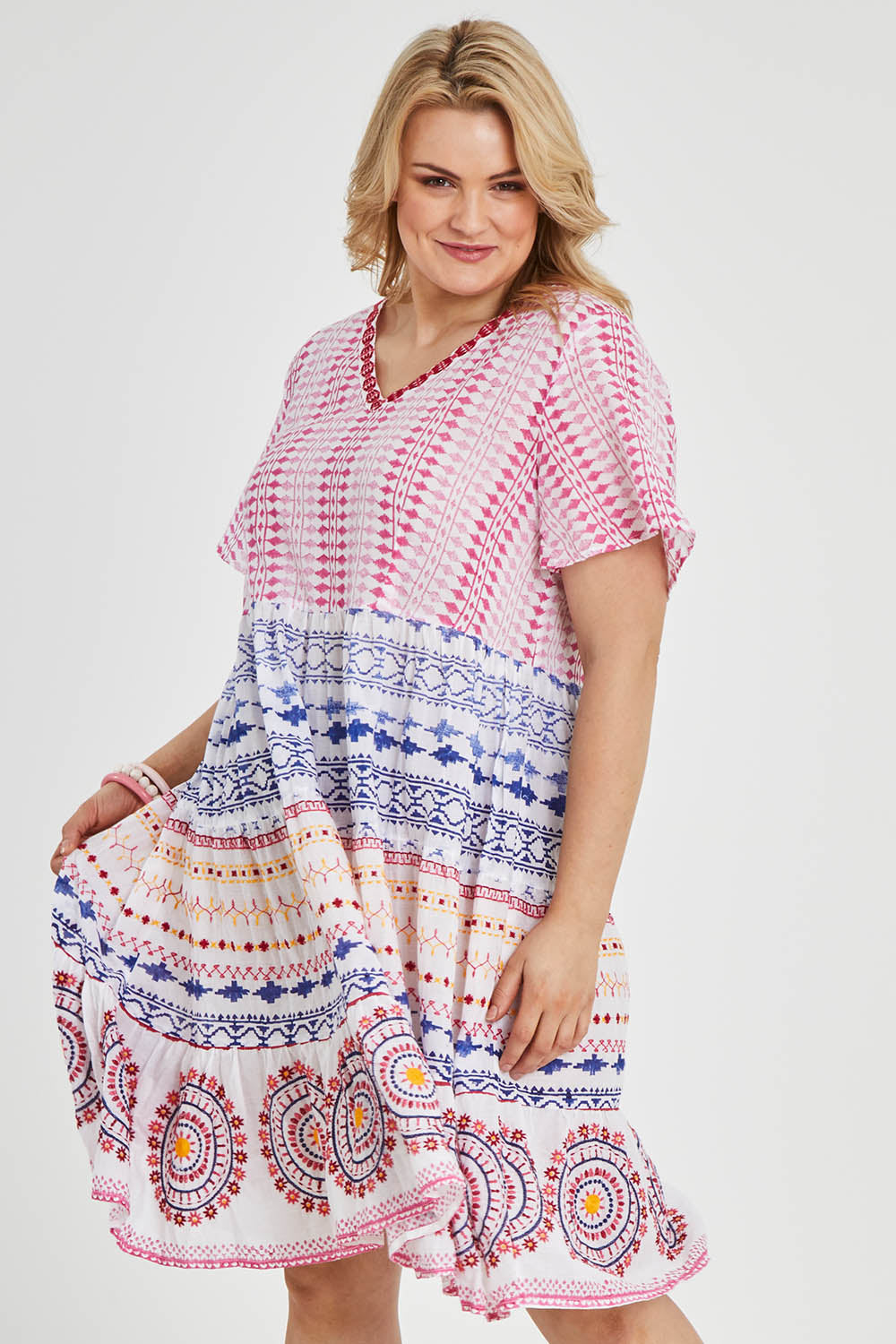 Model Keeara wearing size 16 of the Sealers Cove Cotton Dress in colour Multi (Red), from the front, cropped image