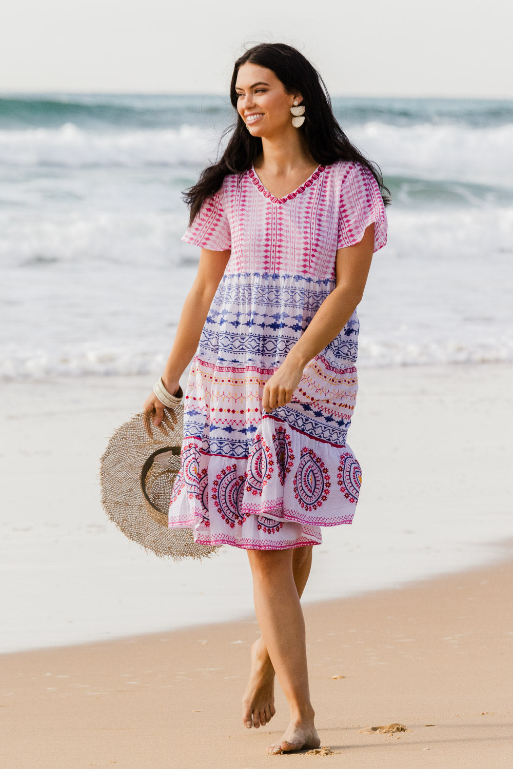 Model Stacey wearing size 10 of the Sealers Cove Cotton Dress in colour Multi (Red), from the front, showing the whole outfit