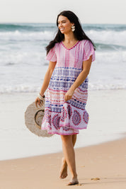 Model Stacey wearing size 10 of the Sealers Cove Cotton Dress in colour Multi (Red), from the front, showing the whole outfit