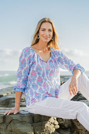 Model Riina wearing size 10 of the Moonta Bay Cotton Blouse in colour Bluepink (Blue), from the front, showing the whole outfit