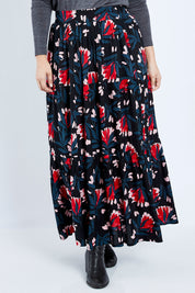 Model Jess wearing size 14 of the Mallory Tier Skirt in colour Paperdaisy (Black), from the front, cropped image