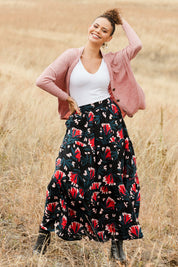 Model Lala wearing size 10 of the Mallory Tier Skirt in colour Paperdaisy (Black), from the front, showing the whole outfit