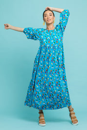 Model Katie wearing size 10 of the Alice Gathered Dress in colour Speckle (Blue), from the front, showing the whole outfit