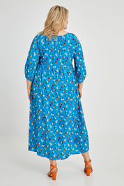 Model Keeara wearing size 16 of the Alice Gathered Dress in colour Speckle (Blue), from the back