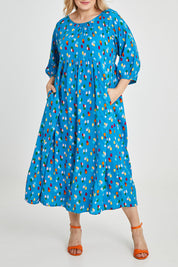 Model Keeara wearing size 16 of the Alice Gathered Dress in colour Speckle (Blue), from the front, cropped image