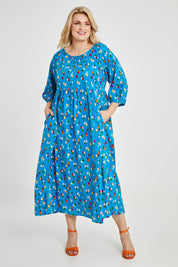 Model Keeara wearing size 16 of the Alice Gathered Dress in colour Speckle (Blue), from the front, showing the whole outfit