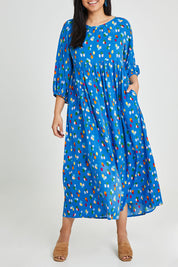 Model Terri-Leigh wearing size 14 of the Alice Gathered Dress in colour Speckle (Blue), from the front, cropped image